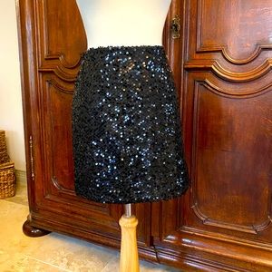 Black sequined mini skirt.